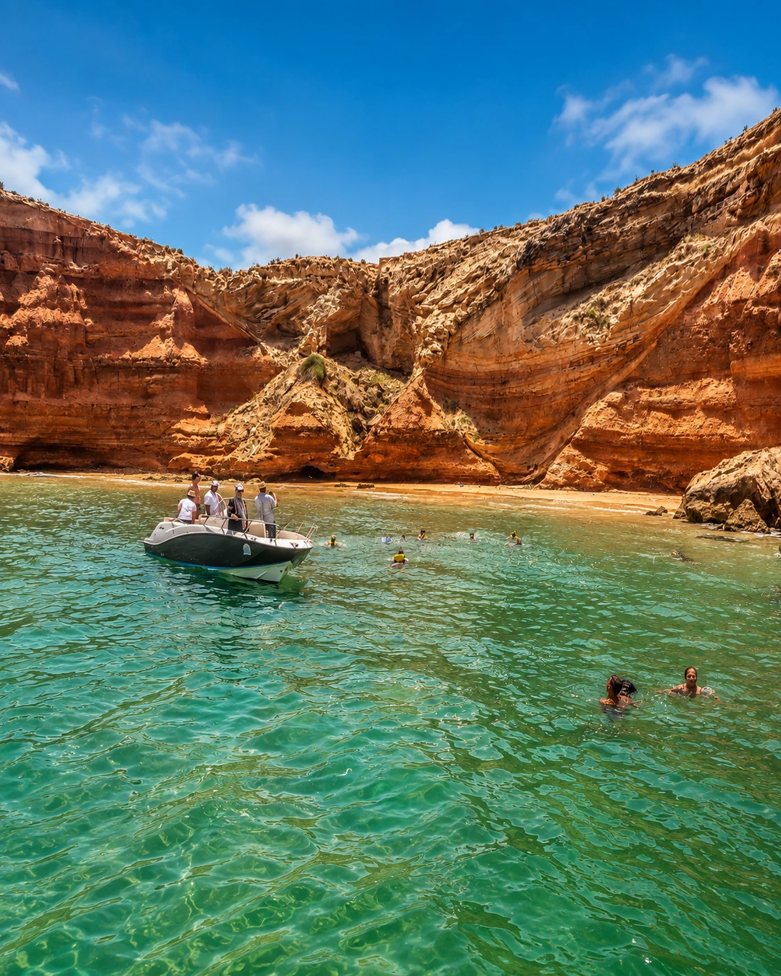 Red coastal cliffs and clear water along the Mediterranean near Nador