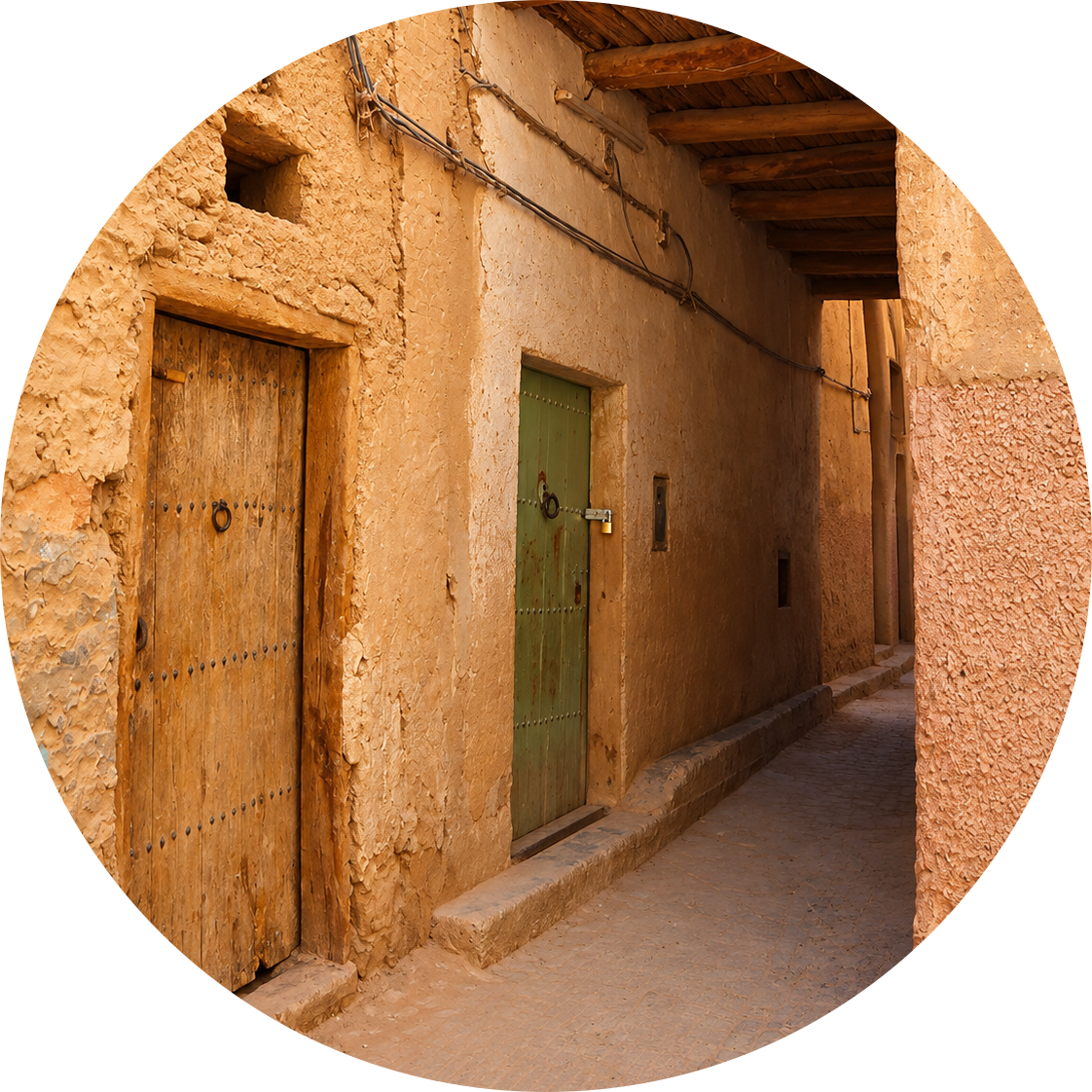 A shaded earthen passage with timber beams and wooden doors