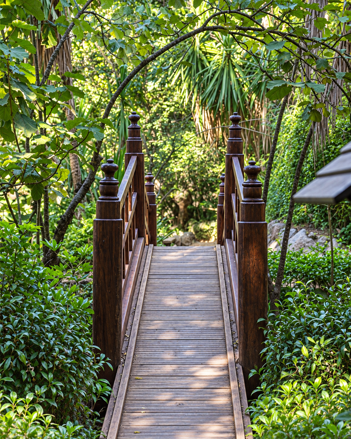 Wooden footbridge among dense vegetation at the Exotic Gardens of Bouknadel