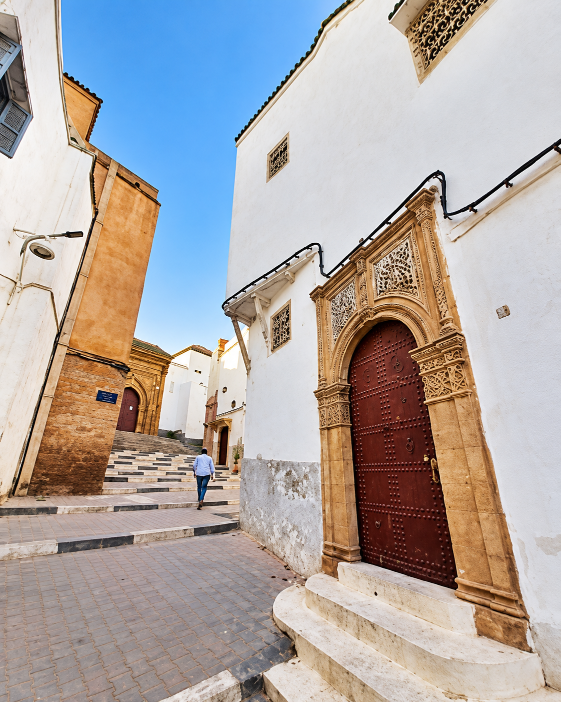 Carved wooden doorway and whitewashed lane in Salé medina