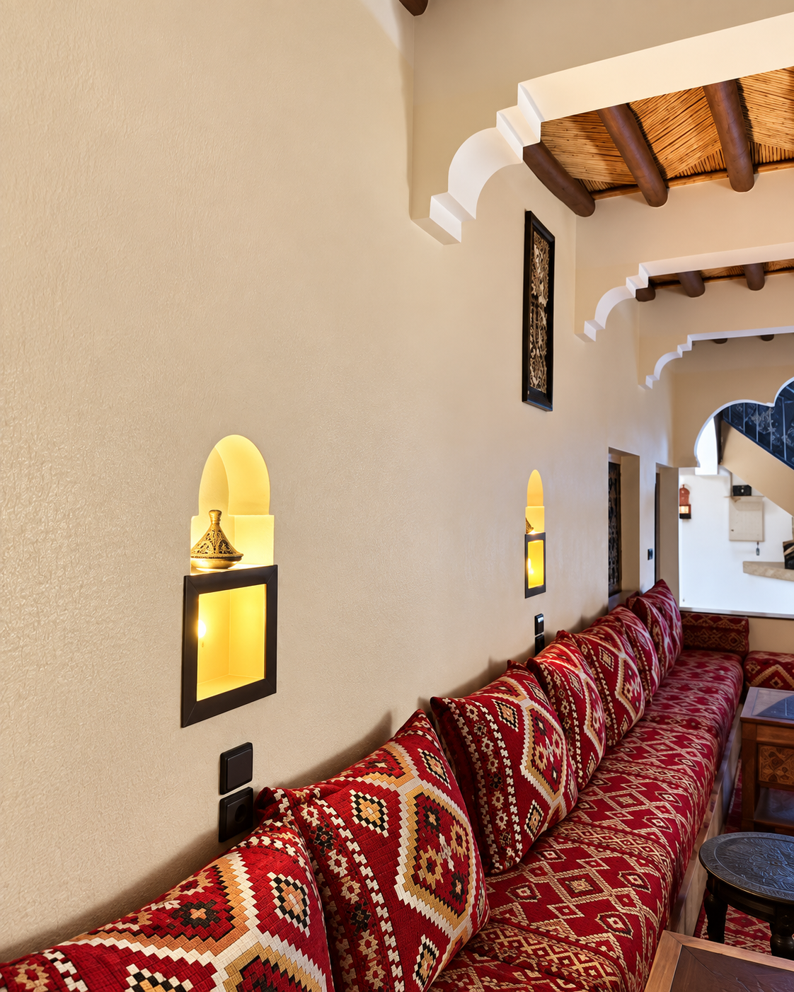 Patterned cushions beneath timber beams and curved interior arches