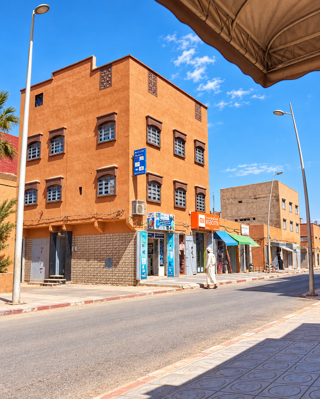 Corner building with neighbourhood shops under a clear sky