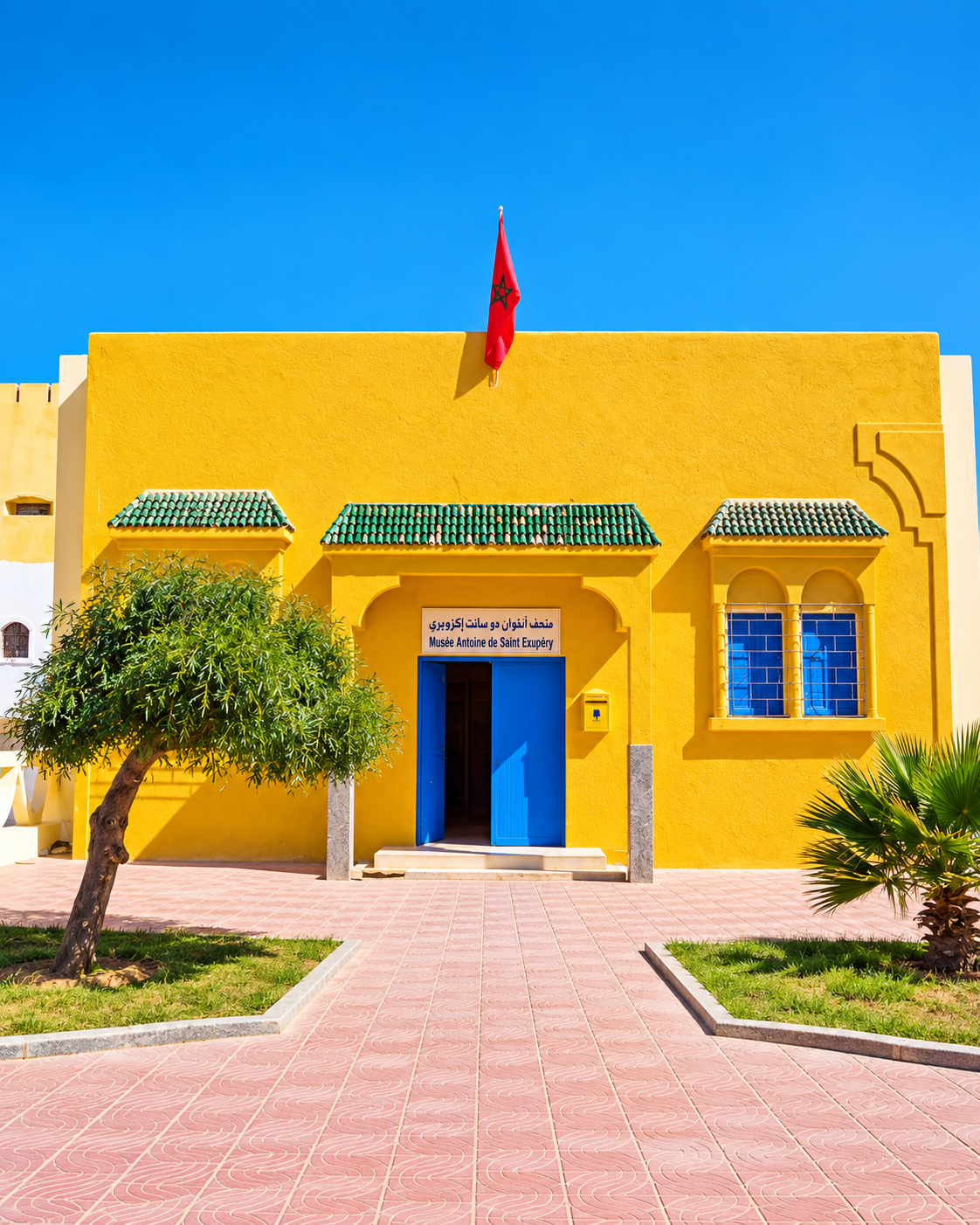 Yellow façade and blue entrance of the Antoine de Saint-Exupéry Museum in Tarfaya