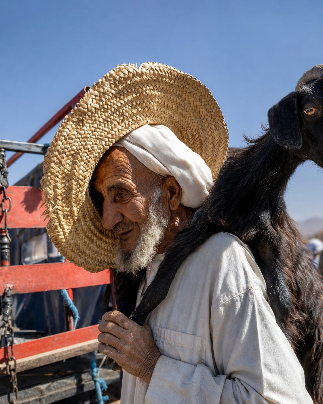 A market trader holding a goat