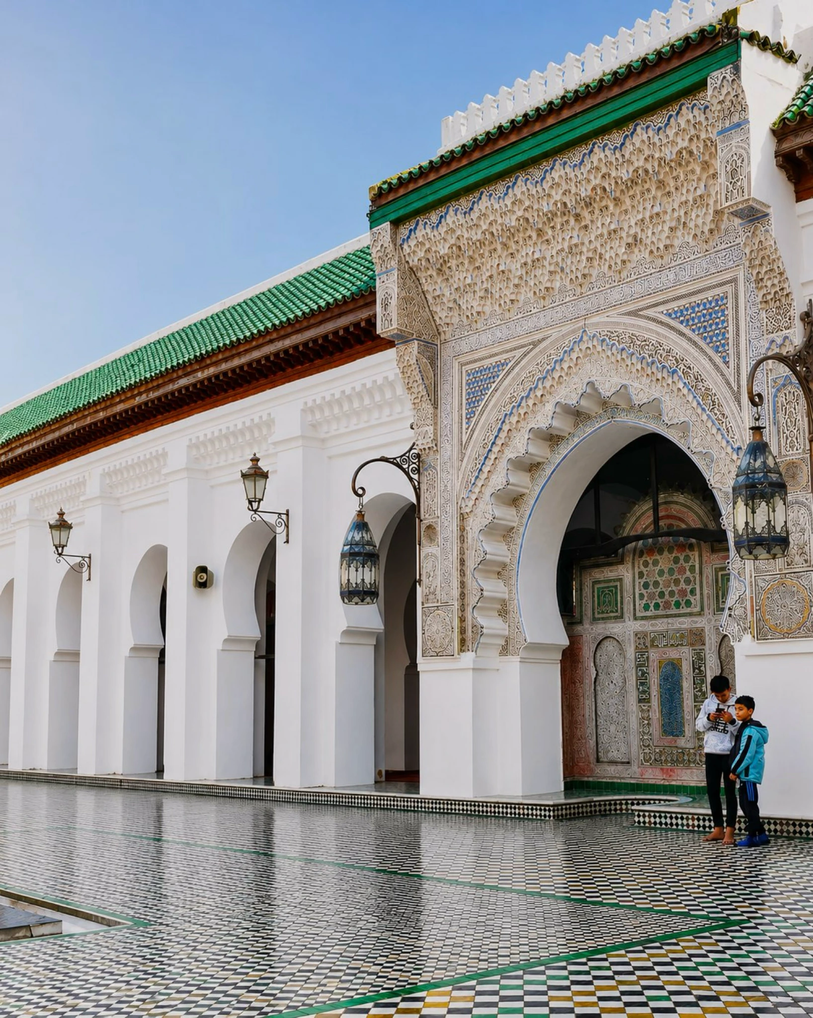 Decorated Al Quaraouiyine entrance and zellij courtyard details in Fez