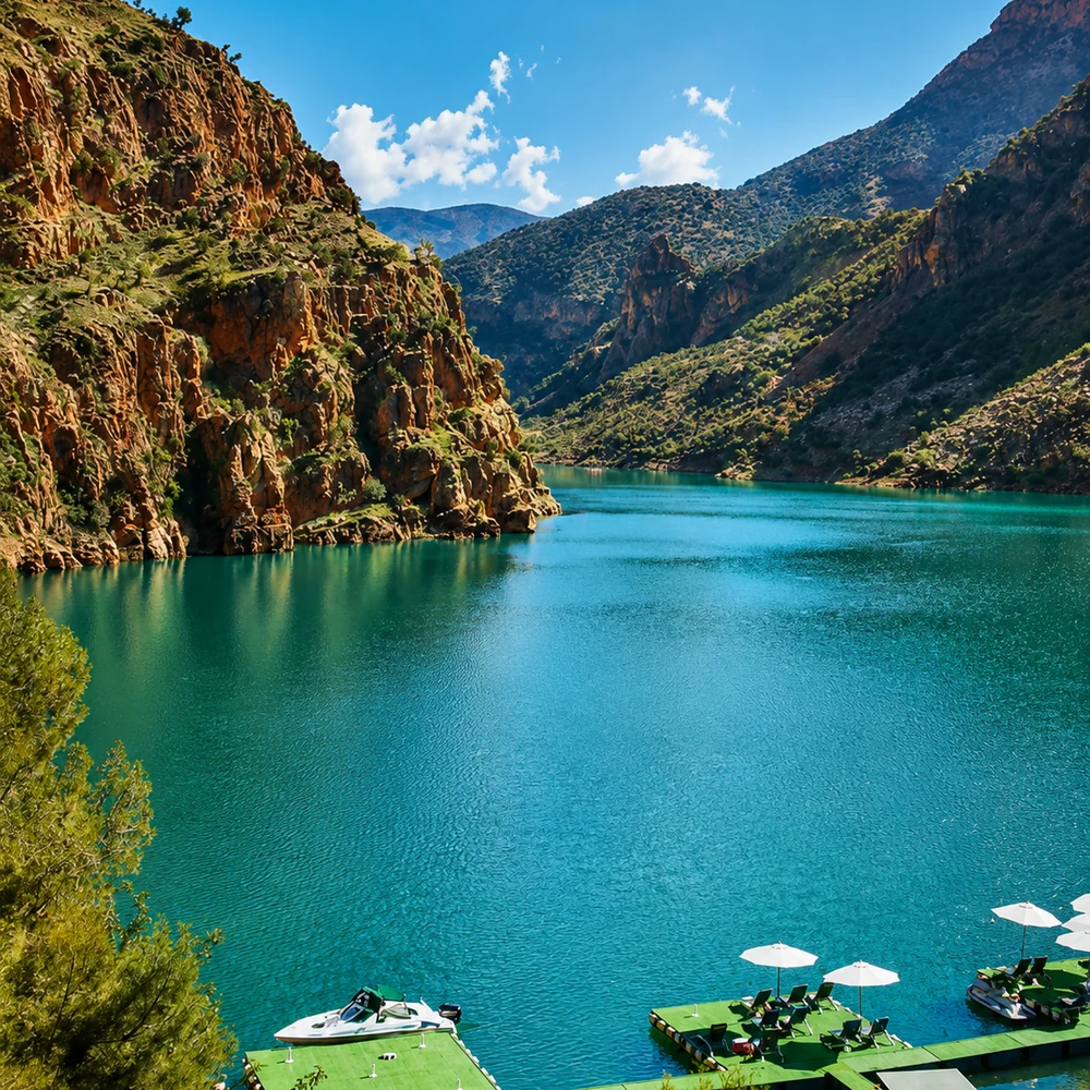 Clear mountain lake framed by rocky Atlas slopes under a blue Moroccan sky