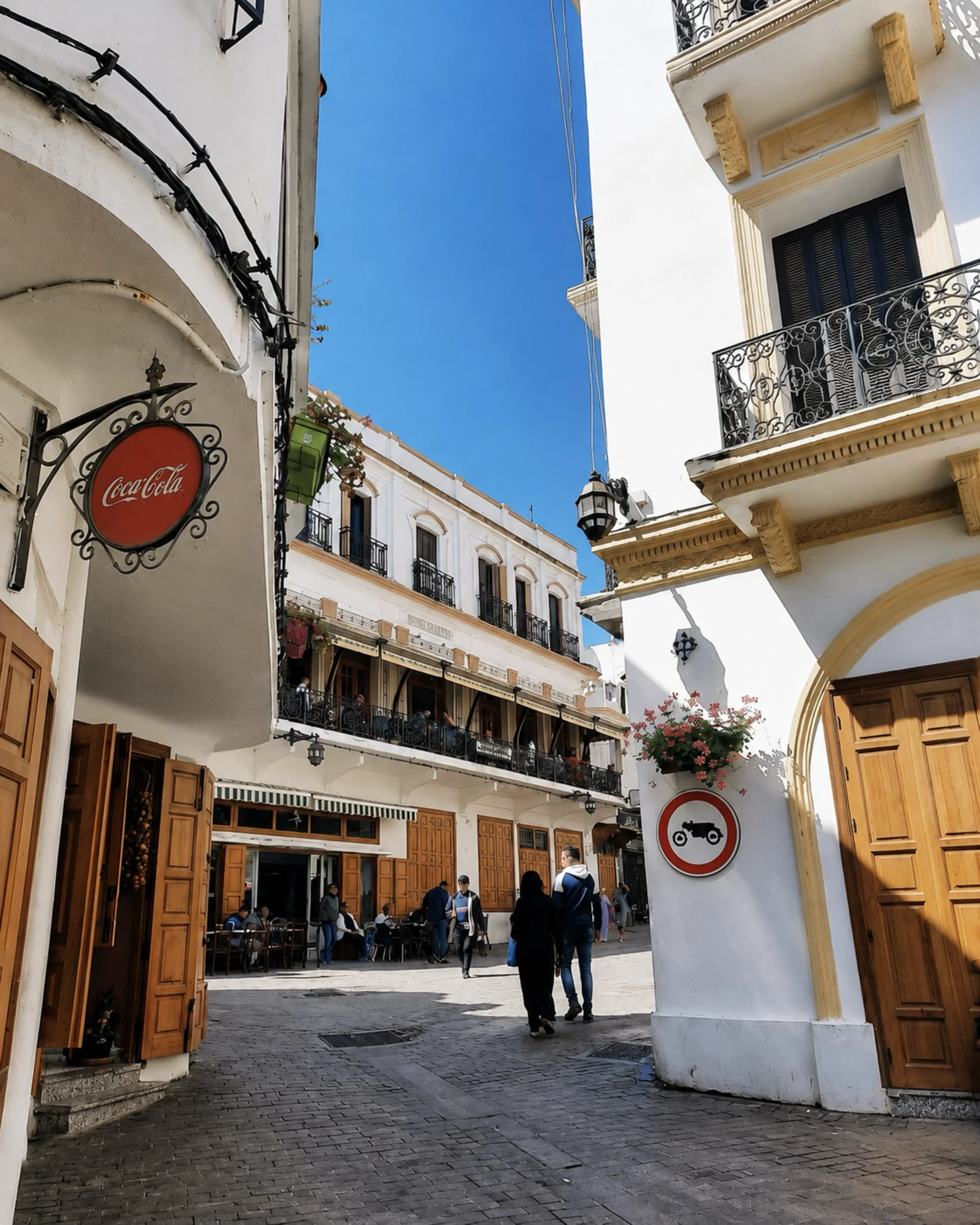 Tangier street with white buildings, balconies and a blue sky near the Cap Spartel city context