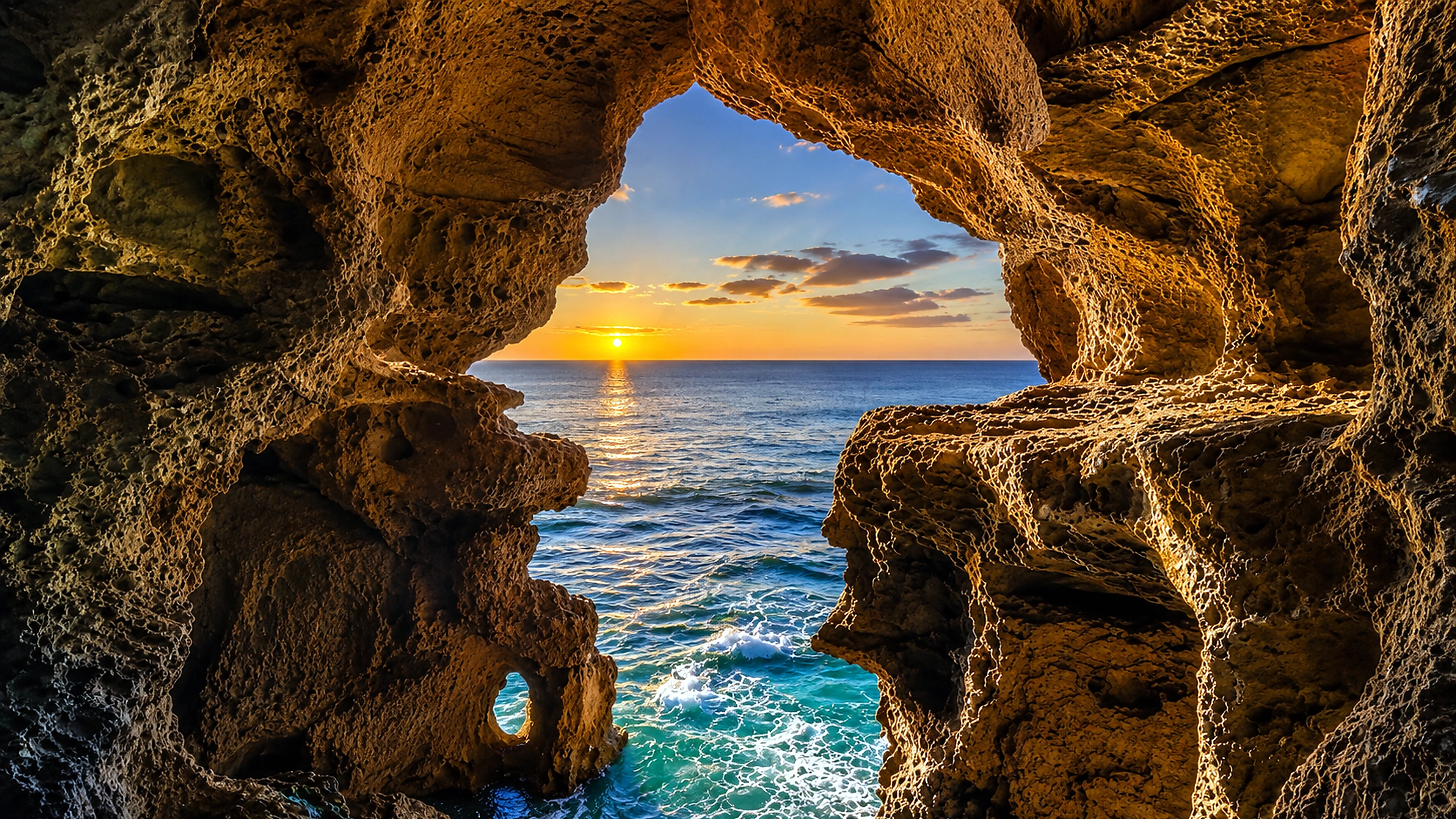 Atlantic sunset seen through the limestone opening of the Caves of Hercules near Tangier, Morocco