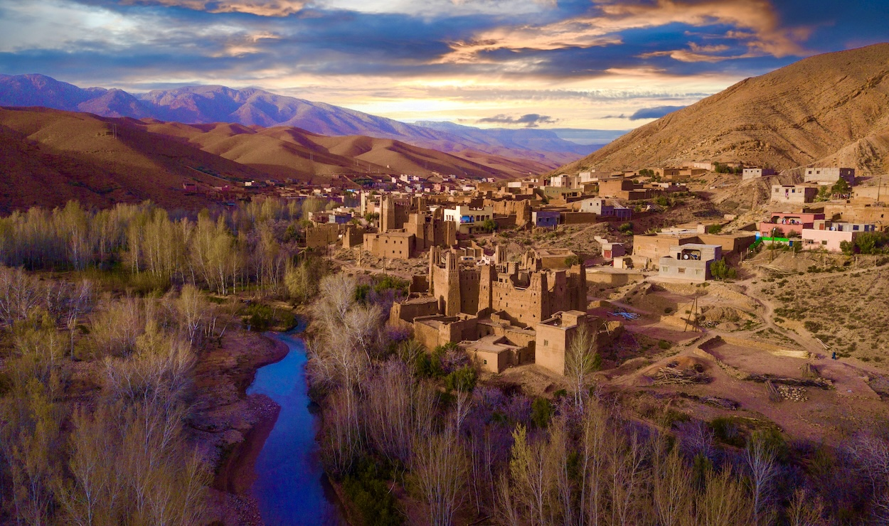 Earthen kasbahs and village houses above a river bend in Dadès Valley