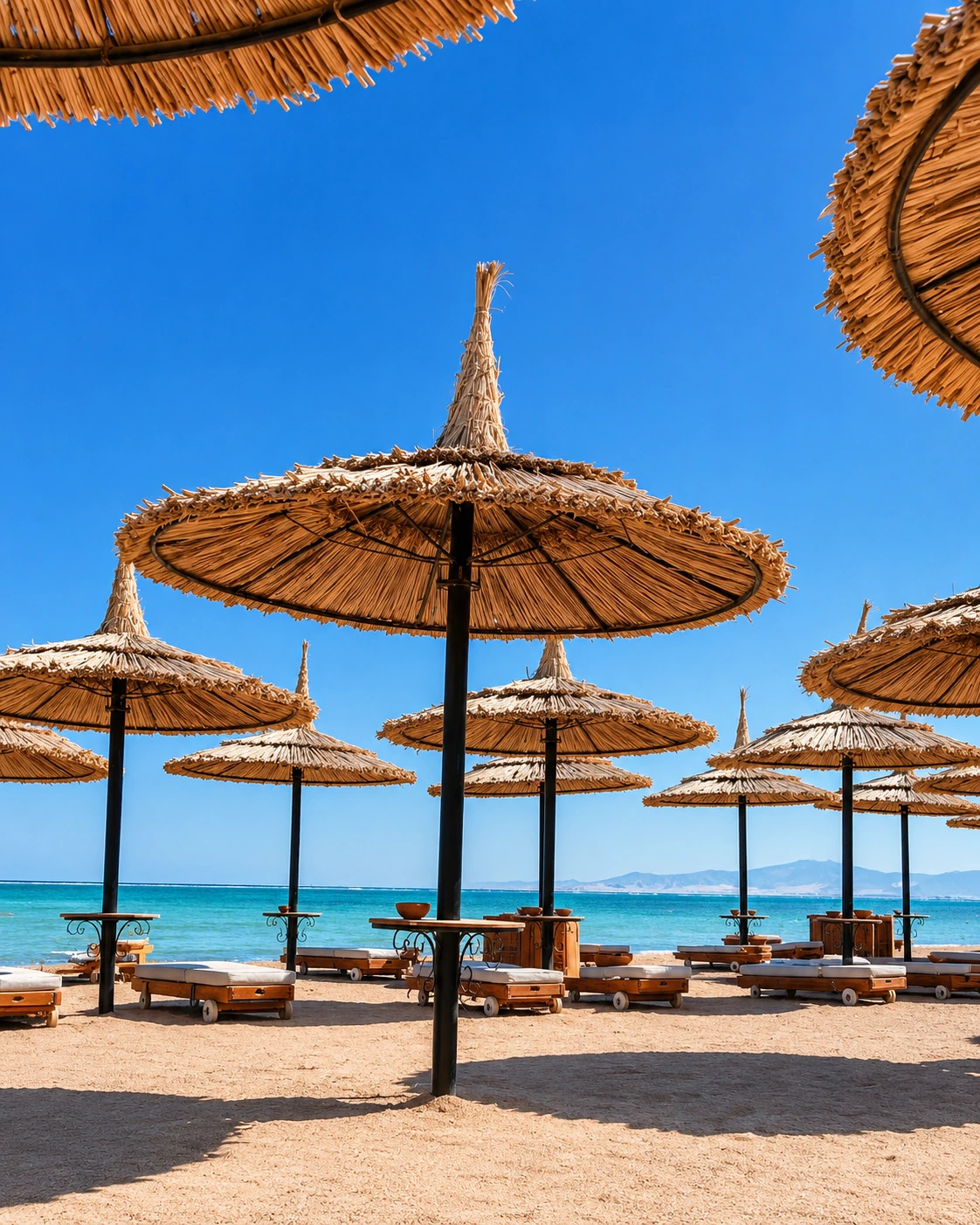 Beach parasols and loungers on the Saïdia coast under a clear Mediterranean sky