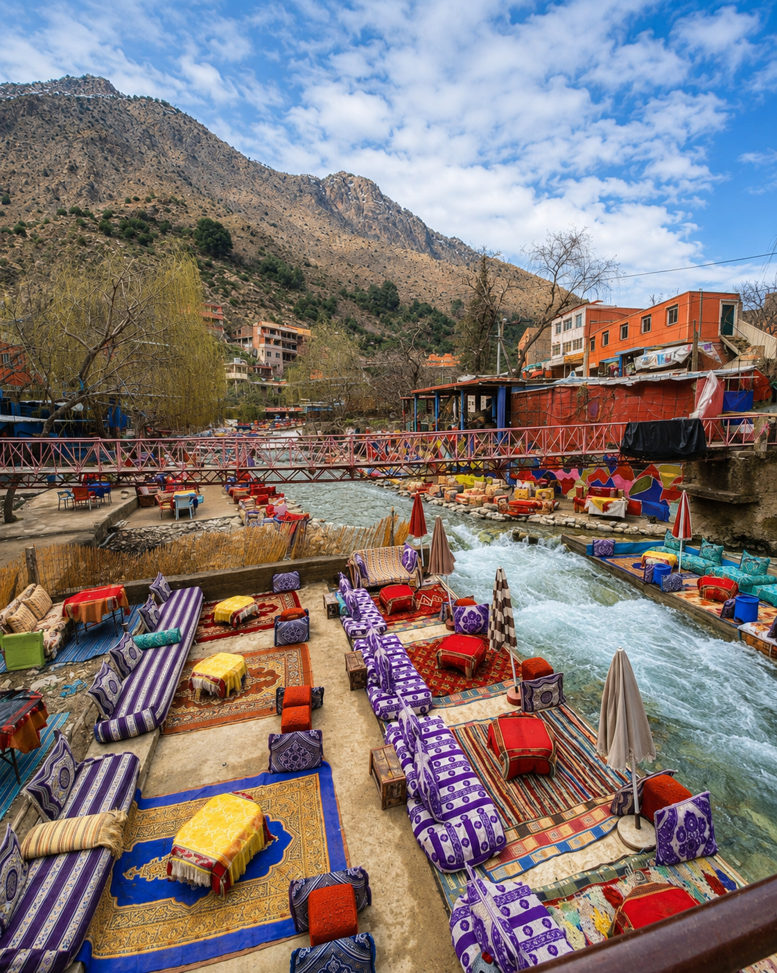 Colourful riverside seating and a footbridge in Setti Fatma, beneath the High Atlas slopes