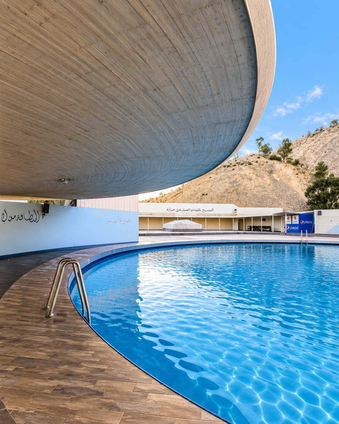 Circular pool beneath a broad concrete canopy at Sidi Harazem