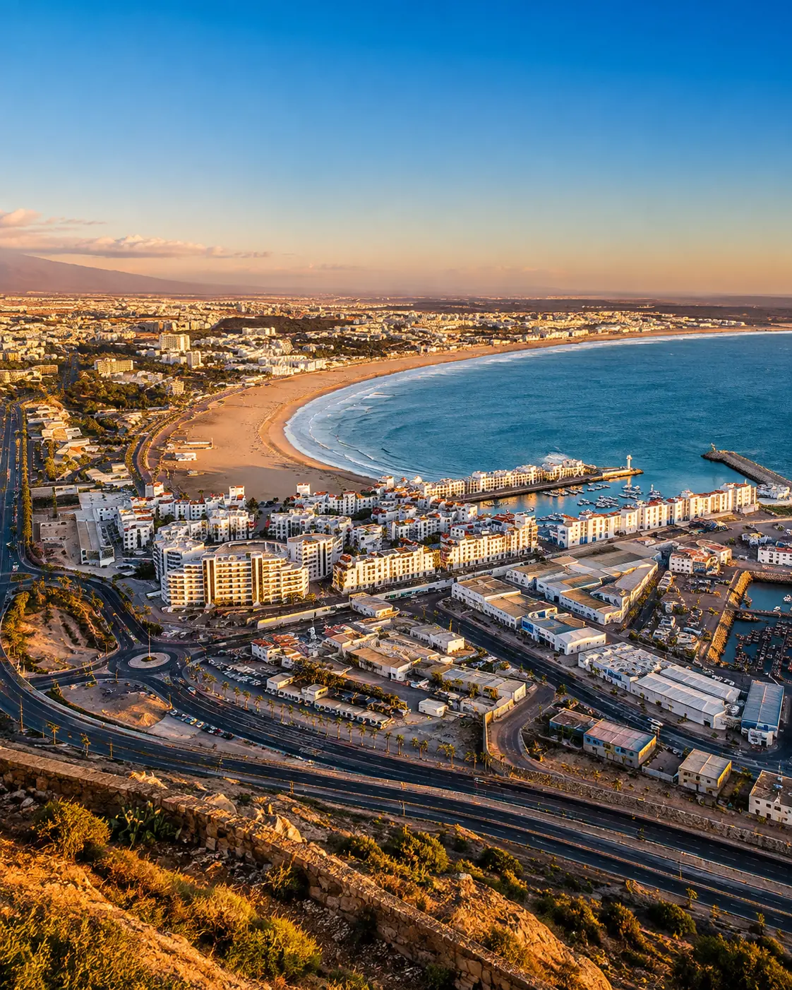 Golden-hour view over Agadir's bay, marina and Atlantic coastline, the city gateway for Souss-Massa National Park