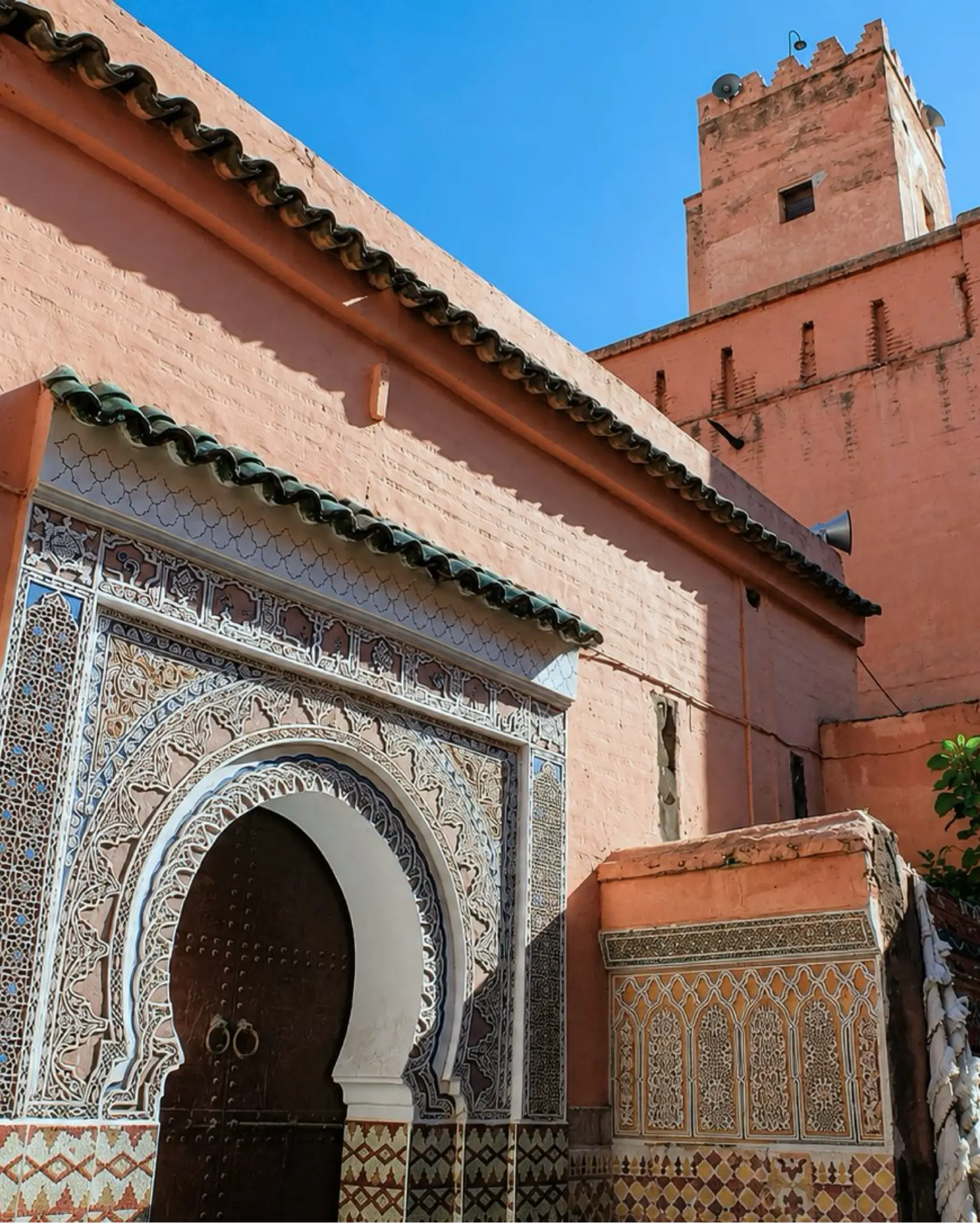 Marrakech architecture with warm rose walls and carved entrance details, the city gateway for Toubkal National Park