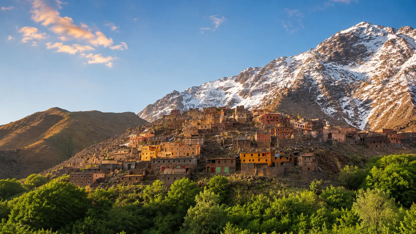 High Atlas village slopes and snow-streaked mountain ridges in the Toubkal landscape